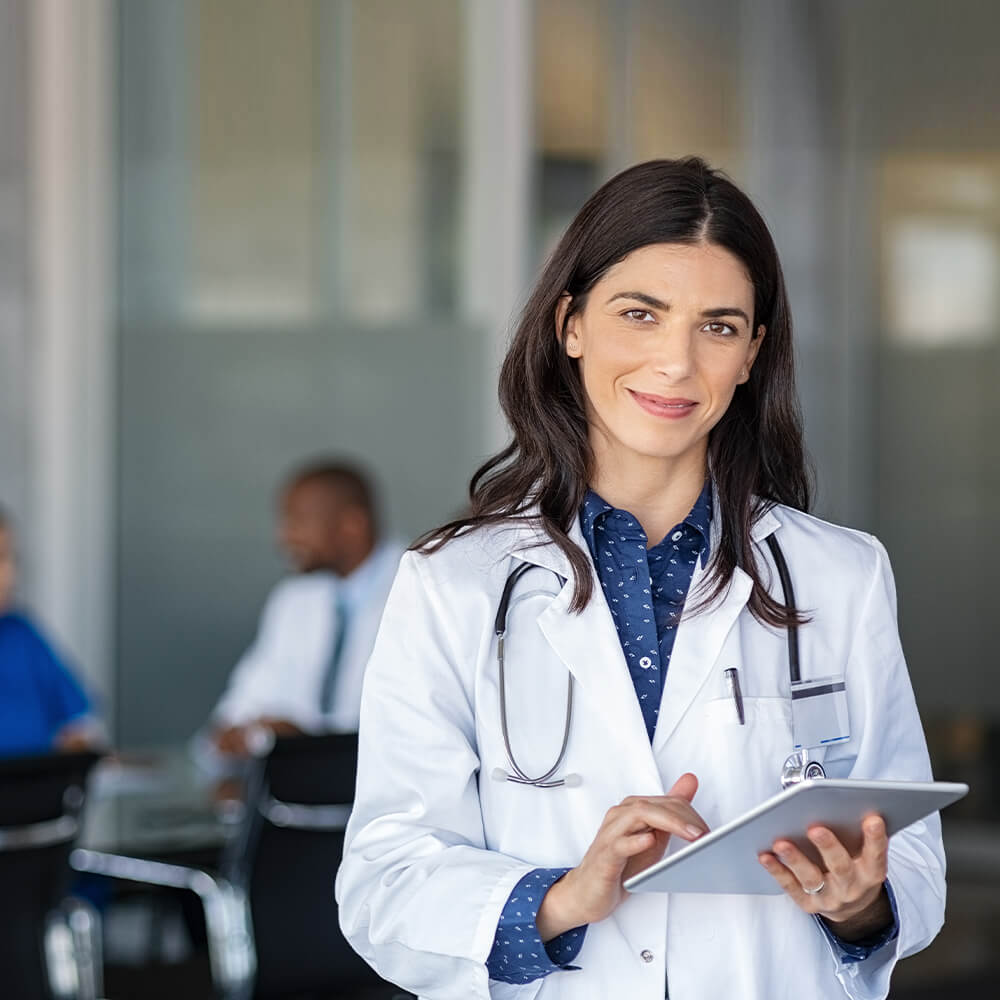 Doctor on iPad looking up solutions for providing competent medical treatment